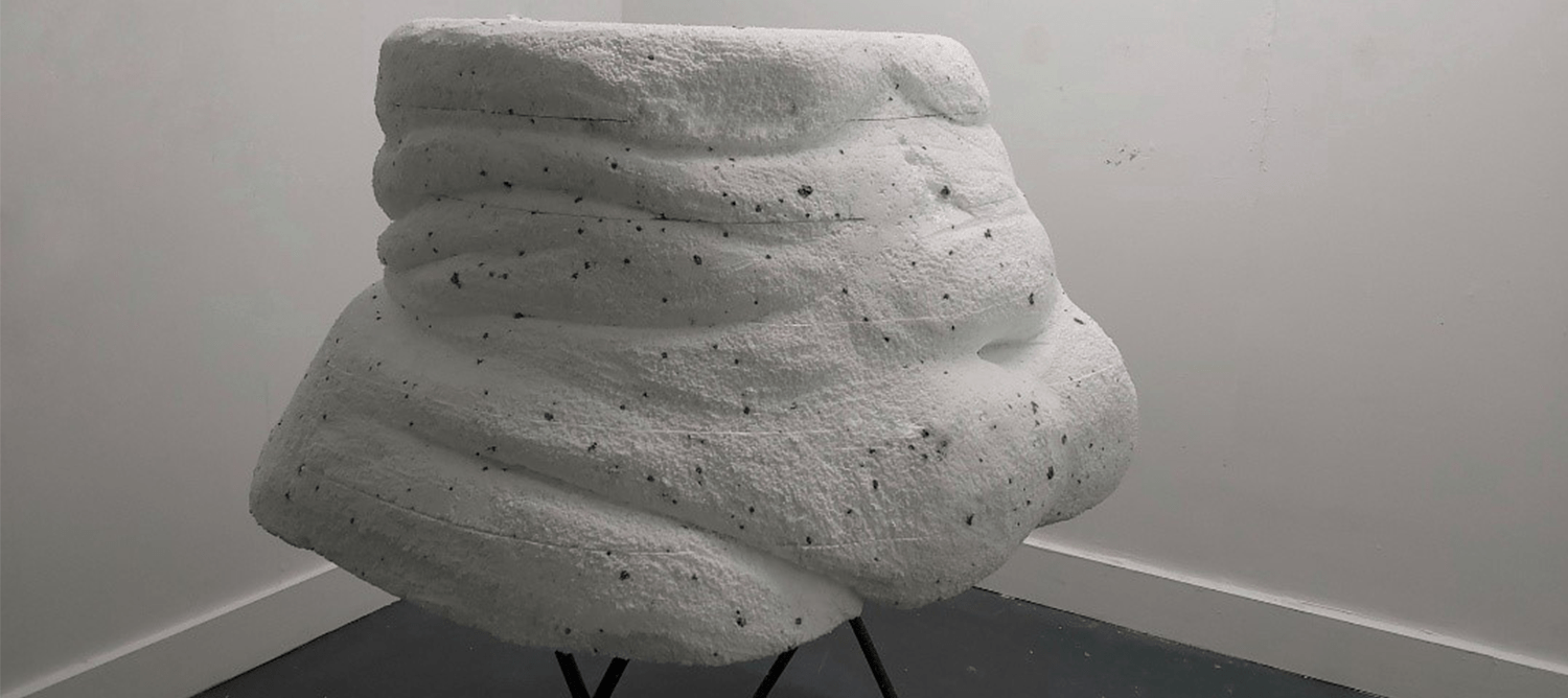 White sculpture cast of human torso.