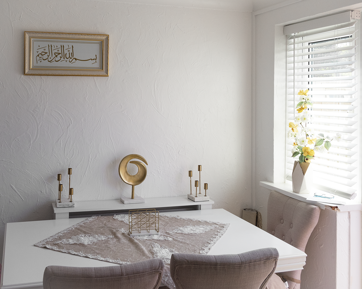 A dining room table with gentle sunlight coming through the window