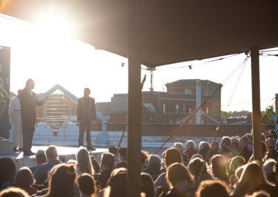 artistic shot with the sun slowly coming down creating silhouettes of the actors