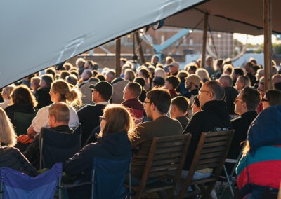 Close up of the audience on a roof under a tent
