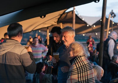 A close of a small group of people standing during the interval talking and smiling