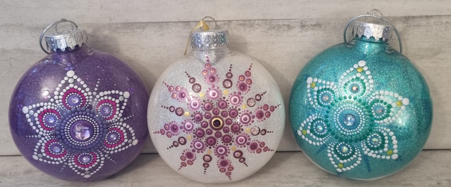 Three Christmas baubles decorated with mandala dots.
